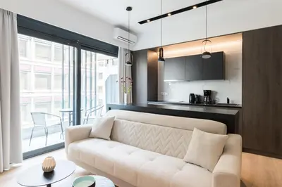 a living room with a white couch and a kitchen at Voda Luxury Residence #301 - Acropolis View Rooftop in Athens