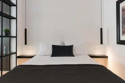 a bedroom with a large bed with white sheets and pillows at Voda Luxury Residence #301 - Acropolis View Rooftop in Athens
