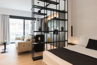 a bedroom with a bed and a couch in a room at Voda Luxury Residence #301 - Acropolis View Rooftop in Athens
