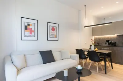 a living room with a white couch and a table at Voda Luxury Residence #302 - Acropolis View Rooftop in Athens