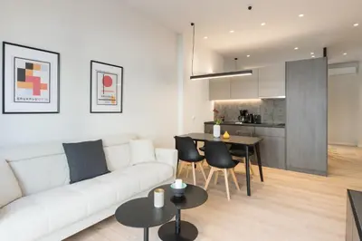 a living room with a white couch and a table at Voda Luxury Residence #302 - Acropolis View Rooftop in Athens