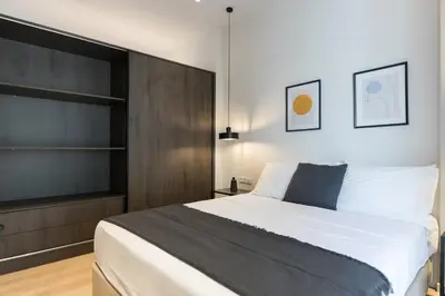 a bedroom with a large bed with a black headboard at Voda Luxury Residence #302 - Acropolis View Rooftop in Athens