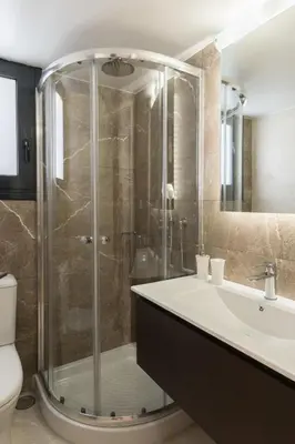 a bathroom with a glass shower and a sink at Voda Luxury Residence #302 - Acropolis View Rooftop in Athens