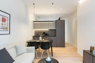 a living room with a white couch and a table at Voda Luxury Residence #302 - Acropolis View Rooftop in Athens