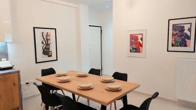 a dining room with a wooden table and chairs at Wonderful apartment in Acropolis in Athens