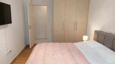 a bedroom with a large bed and a closet at Wonderful apartment in Acropolis in Athens