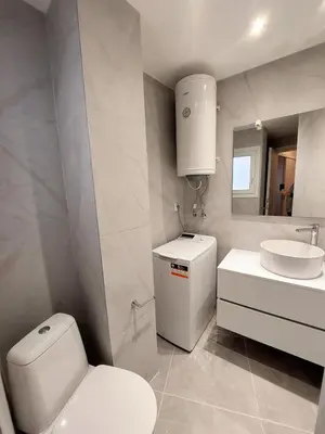 a white bathroom with a toilet and a sink at Wonderful apartment in Acropolis in Athens