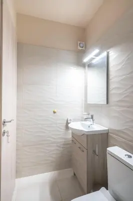a bathroom with a sink and a shower with a mirror at Monastiraki metro st studio for 2 persons by MPS in Athens