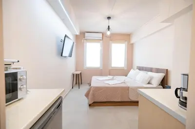 a small room with a bed and a microwave at Monastiraki metro st studio for 2 persons by MPS in Athens