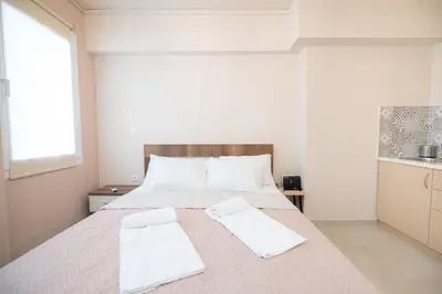 a bedroom with a large bed with two towels on it at Monastiraki metro st studio for 2 persons by MPS in Athens