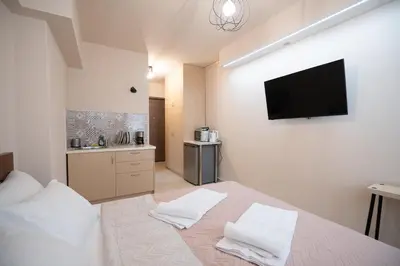a bedroom with a bed with a tv on the wall at Monastiraki metro st studio for 2 persons by MPS in Athens