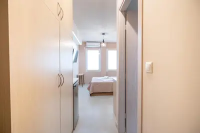 a hallway with a room with a bed in the background at Monastiraki metro st studio for 2 persons by MPS in Athens