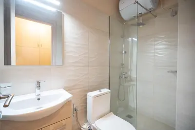 a bathroom with a toilet and a sink and a shower at Monastiraki metro st studio for 2 persons by MPS in Athens