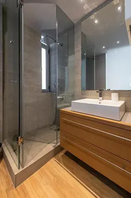 a bathroom with a sink and a shower at Phaedrus Living: Luxury Flat Vouliagmeni in Athens