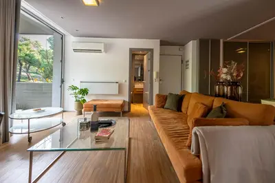 a living room with a couch and a glass table at Phaedrus Living: Luxury Flat Vouliagmeni in Athens