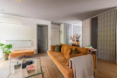 a living room with a couch and a table at Phaedrus Living: Luxury Flat Vouliagmeni in Athens