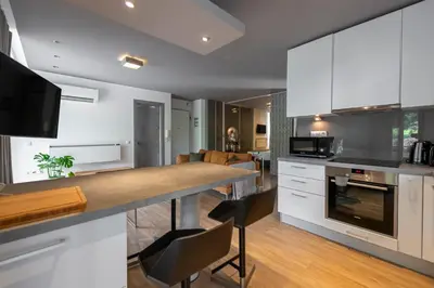 a kitchen with white cabinets and a counter top at Phaedrus Living: Luxury Flat Vouliagmeni in Athens