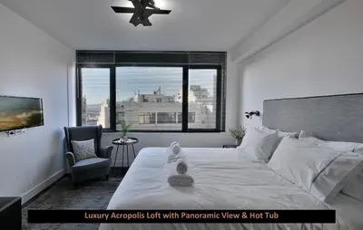 a bedroom with a bed with a chair and a window at ATER ALBUS by K&K in Athens