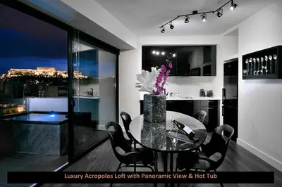 a dining room with a table with a vase of flowers at ATER ALBUS by K&K in Athens