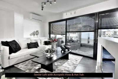 a living room with a white couch and a table at ATER ALBUS by K&K in Athens