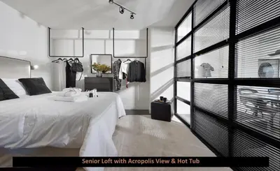 a bedroom with a white bed and a large window at ATER ALBUS by K&K in Athens