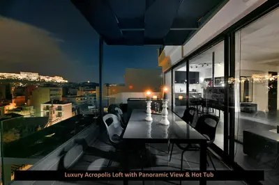 a table and chairs on a balcony with a view at ATER ALBUS by K&K in Athens