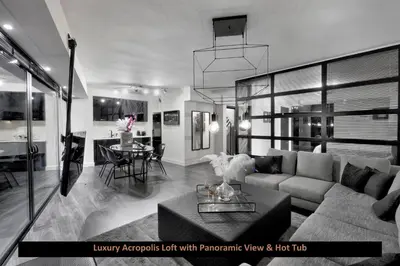 a living room with a couch and a table at ATER ALBUS by K&K in Athens