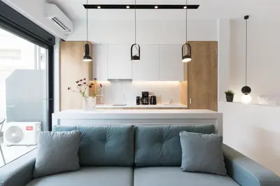 a living room with a couch and a kitchen at Voda Luxury Residence #401 - Acropolis View Rooftop in Athens