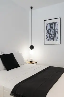 a bedroom with a white bed with a black blanket at Voda Luxury Residence #401 - Acropolis View Rooftop in Athens