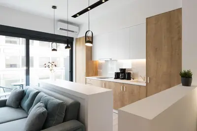 a living room with a couch and a kitchen at Voda Luxury Residence #401 - Acropolis View Rooftop in Athens