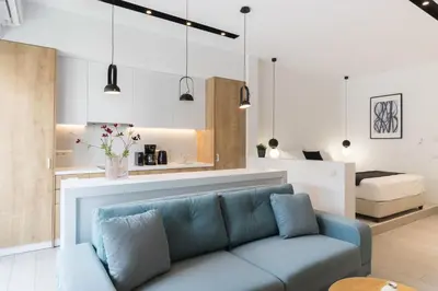 a living room with a blue couch and a bedroom at Voda Luxury Residence #401 - Acropolis View Rooftop in Athens