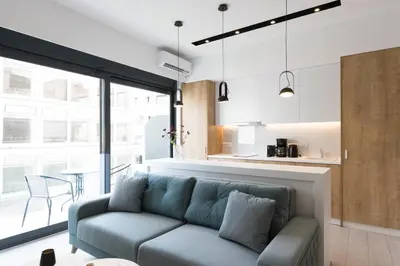 a living room with a couch and a table at Voda Luxury Residence #401 - Acropolis View Rooftop in Athens