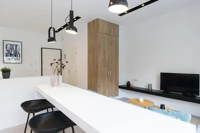 a kitchen with a white counter and two stools at Voda Luxury Residence #401 - Acropolis View Rooftop in Athens