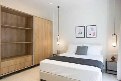 a bedroom with a large bed and wooden cabinets at Voda Luxury Residence #402 - Acropolis View Rooftop in Athens