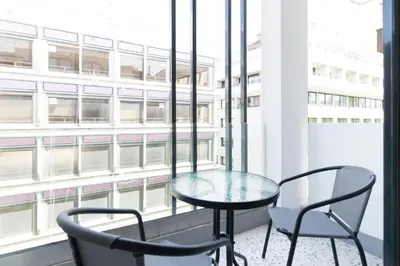 a table and two chairs in front of a window at Voda Luxury Residence #402 - Acropolis View Rooftop in Athens