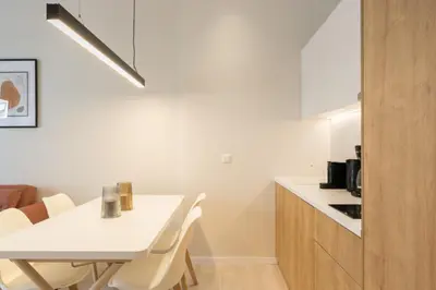 a kitchen with a white table and chairs and a counter at Voda Luxury Residence #402 - Acropolis View Rooftop in Athens