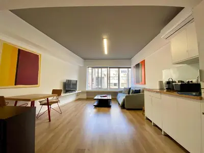 a living room with a couch and a table at Mosaikon Guesthouses #Nikiou Str in Athens