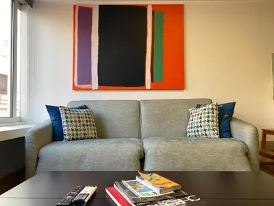 a living room with a couch and a table at Mosaikon Guesthouses #Nikiou Str in Athens