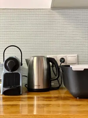 a kitchen counter with a tea kettle and a mixer at Mosaikon Guesthouses #Nikiou Str in Athens