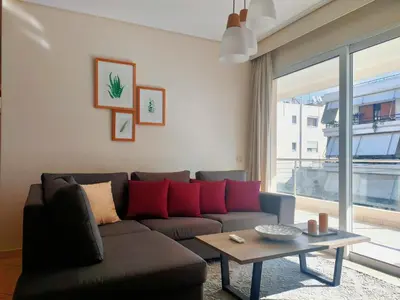 a living room with a couch and a table at Alimos seaview apartment in Athens