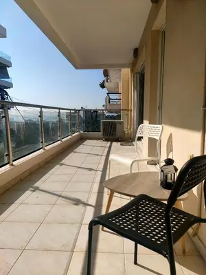 a patio with a table and chairs on a balcony at Alimos seaview apartment in Athens