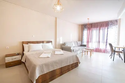 a bedroom with a bed and a living room at Monastiraki metro station studio for 4 pers by MPS in Athens