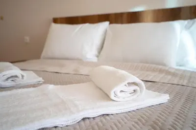 a bed with two towels on top of it at Monastiraki metro station studio for 4 pers by MPS in Athens