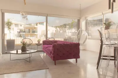 a living room with a purple couch and a table at Luxury Apartment near Acropolis-Living Stone Gold in Athens