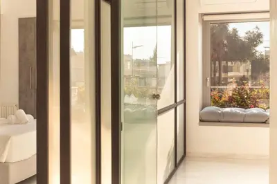 a room with glass doors and a window with a view at Luxury Apartment near Acropolis-Living Stone Gold in Athens