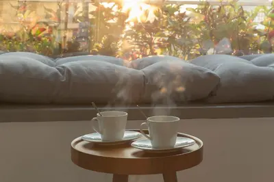 two coffee cups on a table in front of a couch at Luxury Apartment near Acropolis-Living Stone Gold in Athens