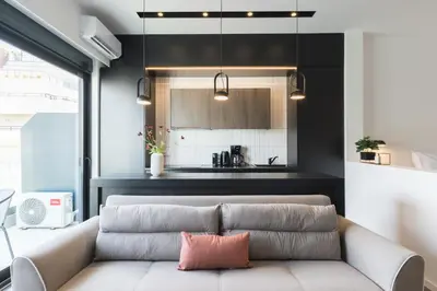 a living room with a couch and a kitchen at Voda Luxury Residence #501 - Acropolis View Rooftop in Athens