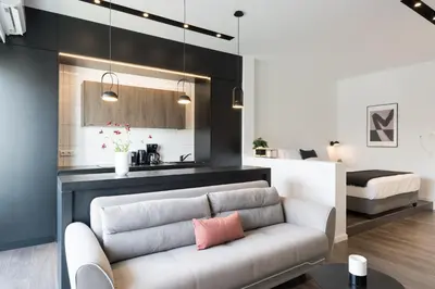 a living room with a couch and a bedroom at Voda Luxury Residence #501 - Acropolis View Rooftop in Athens