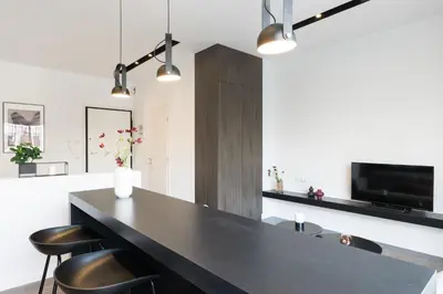 a kitchen with a black counter and some chairs at Voda Luxury Residence #501 - Acropolis View Rooftop in Athens