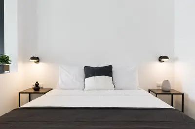 a bedroom with a large bed with white sheets and pillows at Voda Luxury Residence #501 - Acropolis View Rooftop in Athens